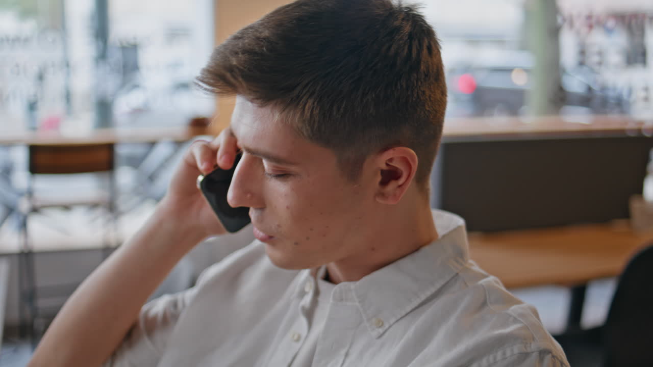 Happy man calling smartphone at workplace closeup. Smiling businessman talking