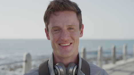 portrait handsome young red head man smiling happy enjoying successful lifestyle relaxing on warm summer day seaside slow motion