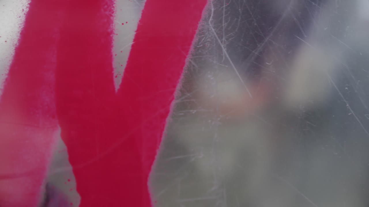 художник-граффити рисует на стеклянной стене 4k