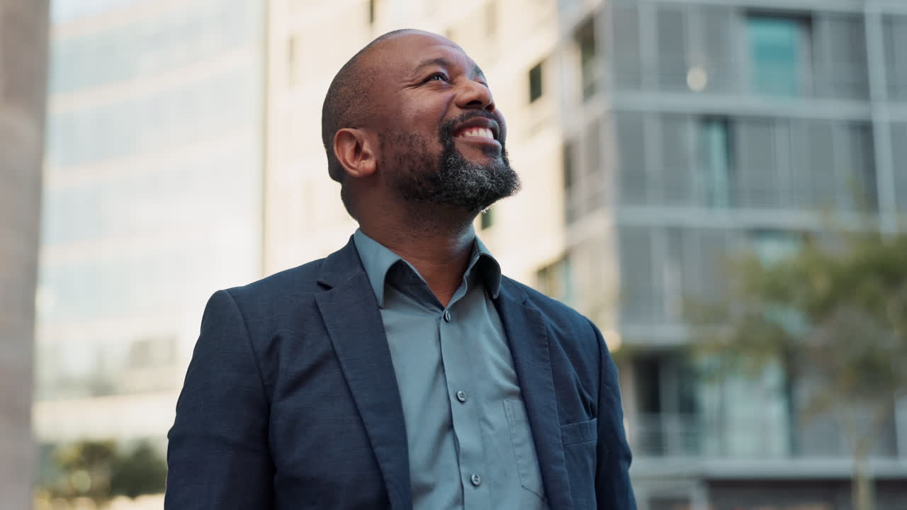 Happy Businessman Looking Up in City