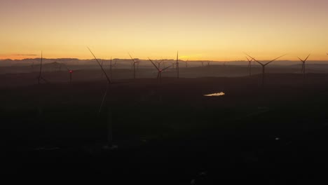 aerial view of wind turbines at sunset