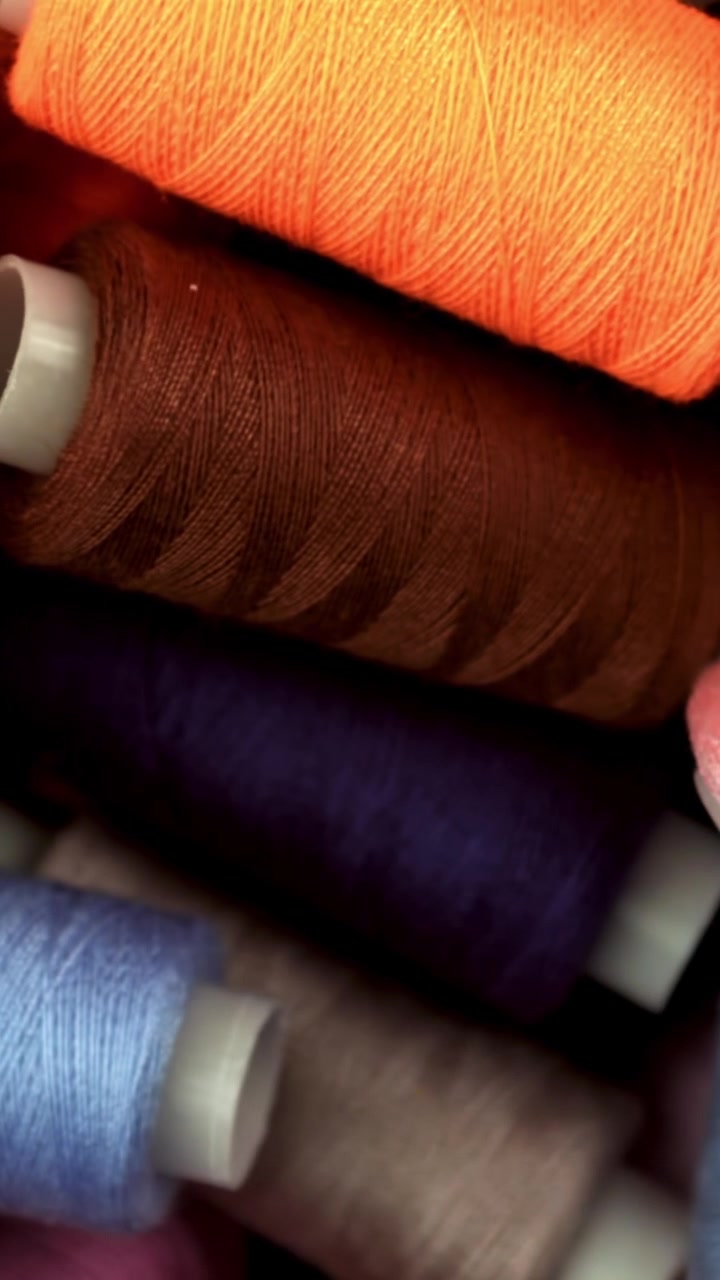 Close-Up View of Colorful Sewing Thread Spools