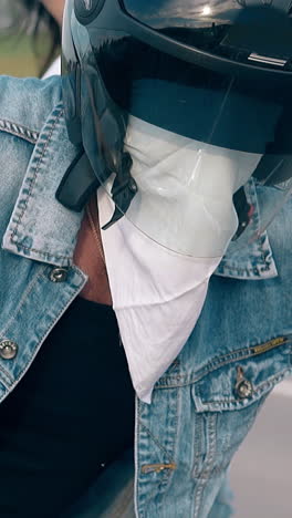 close view couple gets off motorcycle and muscular man takes off black helmet and white sling slow motion