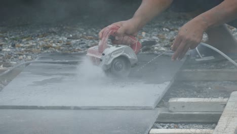 man cutting granite stone