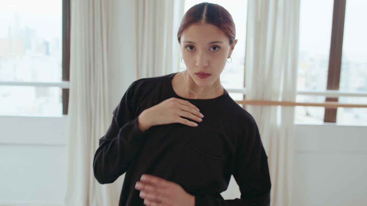 Young Beautiful Girl Dancing and Looking at Camera