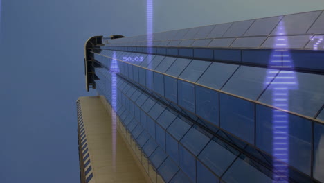 digital data and graphs animating over skyscraper's reflective glass facade