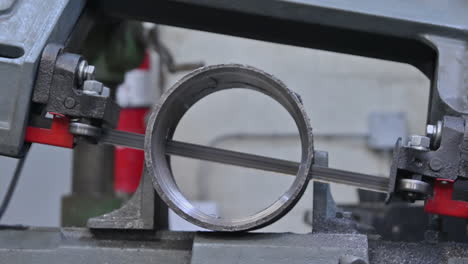 precision in motion: chop band saw slicing through a 4" coupling