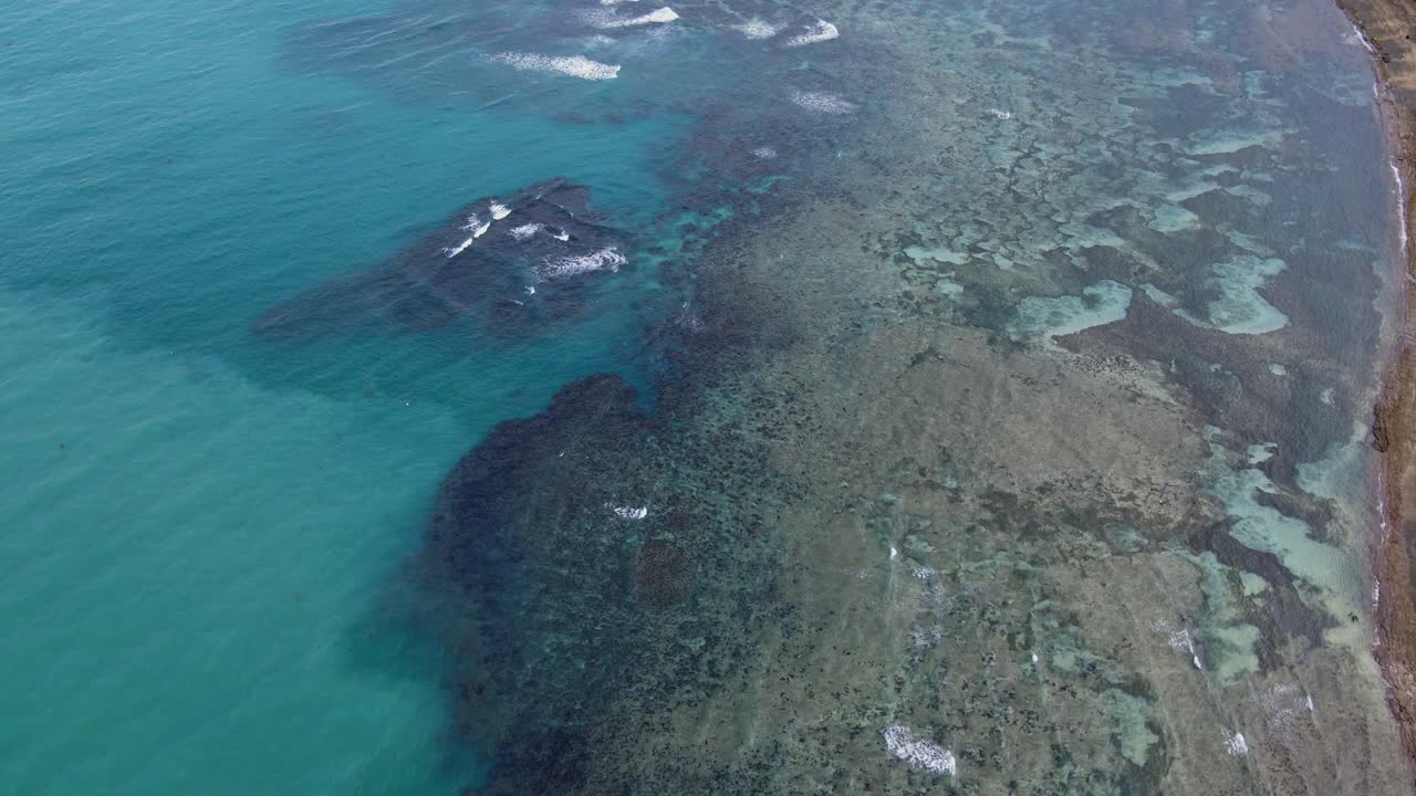 Aerial Flyover of Shallow Fringing Reef and Clear Turquoise Waters Along Tropical Island Coastline at Catanduanes, Philippines