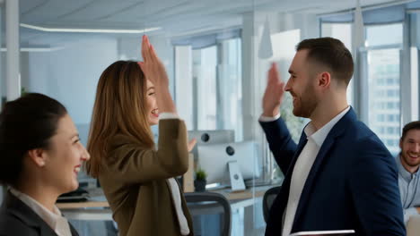 business team collaboration and high-five celebration in office