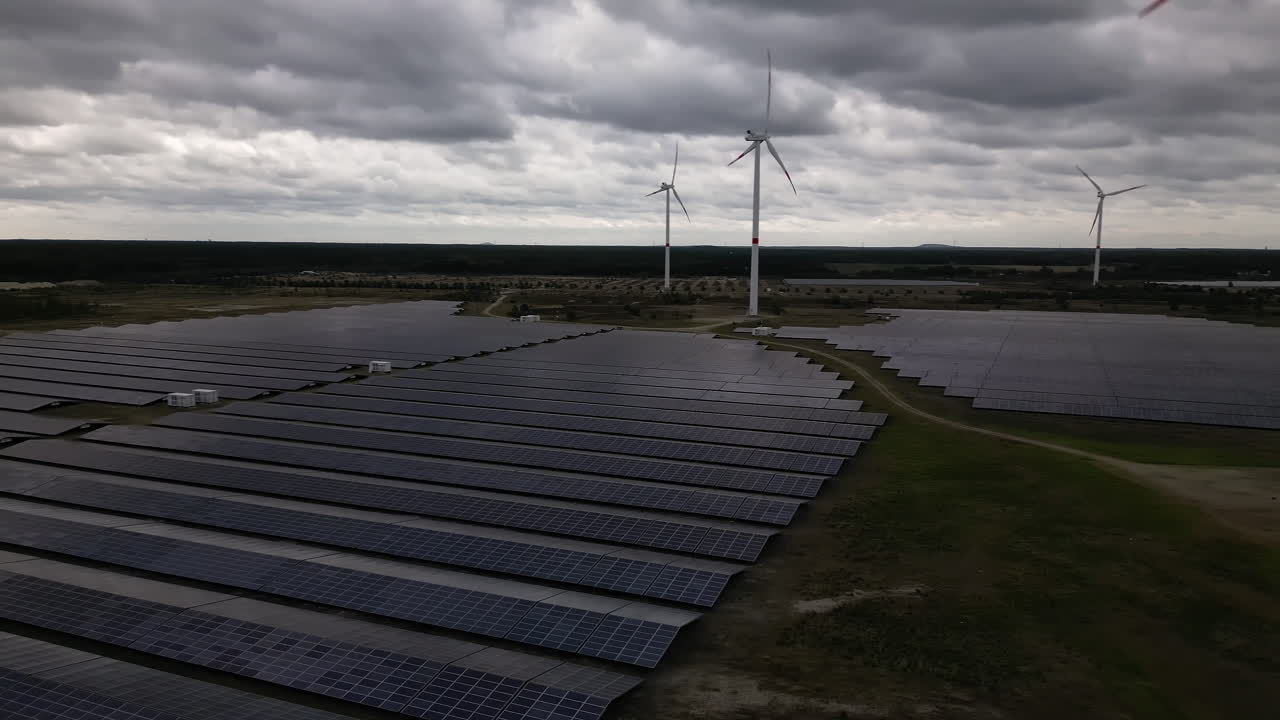 Stormy clouds above solar farm, aerial pan view