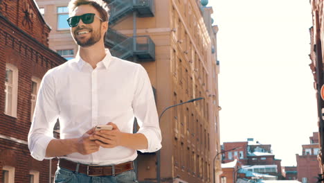 man using phone in city street