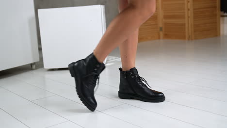 woman wearing black leather ankle boots