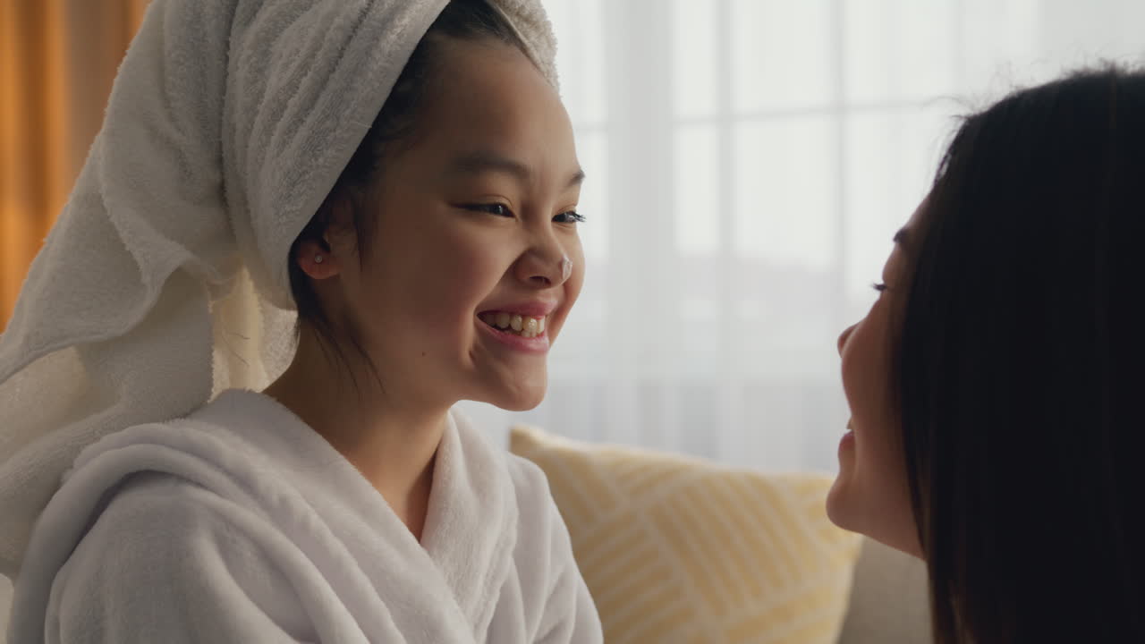 Daughter and Mother Doing a Facial Mask Treatment