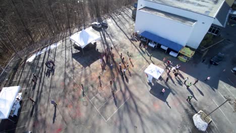 a drone shot of a crowd in a parking lot