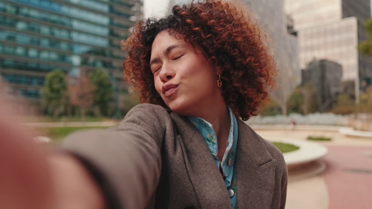 Happy Young Woman Waving at the Camera in the City