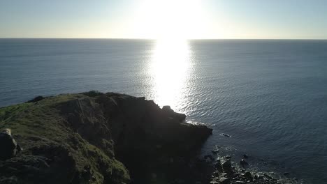 young woman looking out at the beautiful ocean view, aerial shot