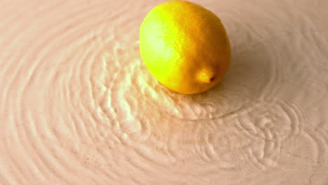 lemon spinning on wet white surface