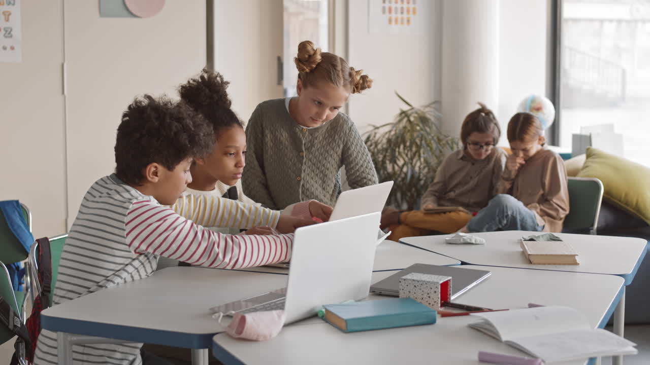 Schoolkids Playing on Laptop in Classroom