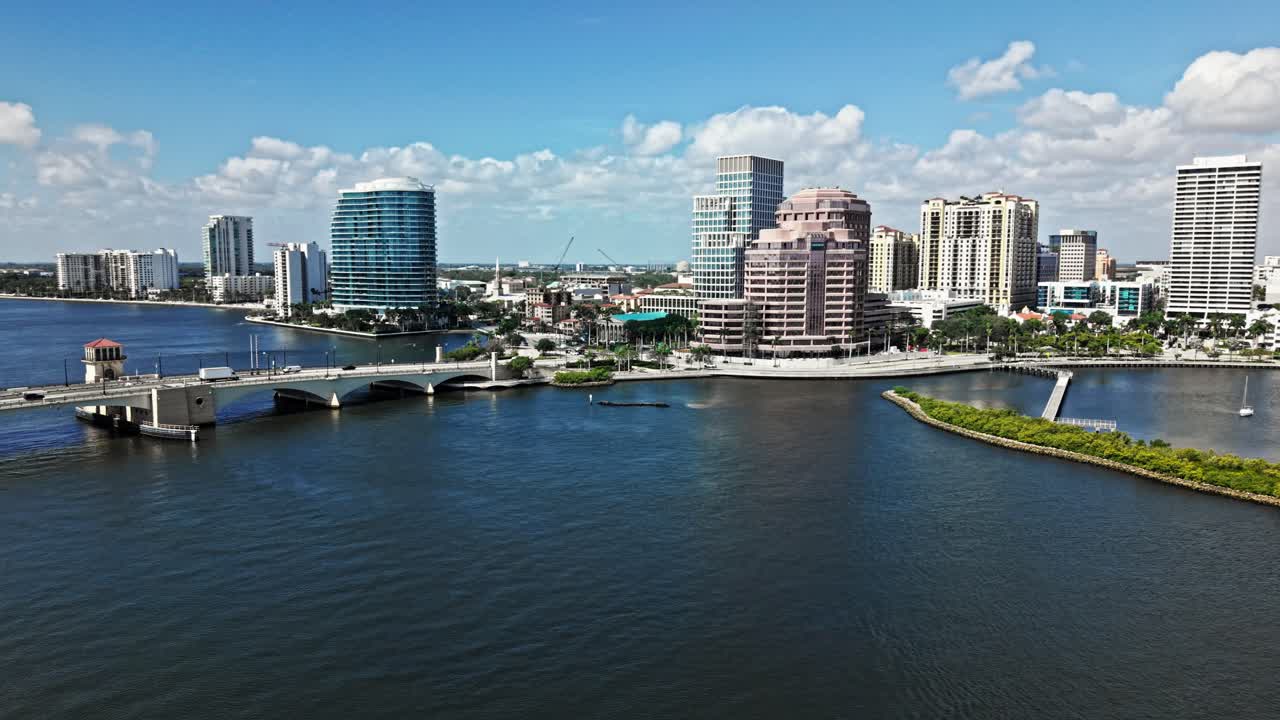 Orbit drone shot of cityscape with Royal Park Bridge, One Flagler and Phillips Point building in West Palm Beach, Florida, USA