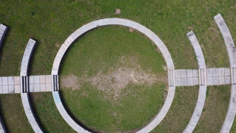 aerial view of circular concentric pattern construction in da riouxa park, vigo, pontevedra, spain. gentle rise shot.