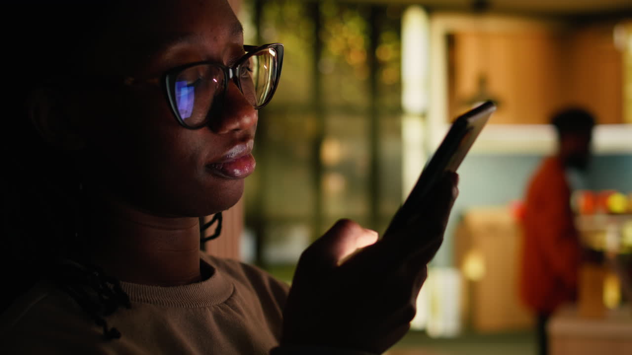 African American young woman relaxing alone and checking apps