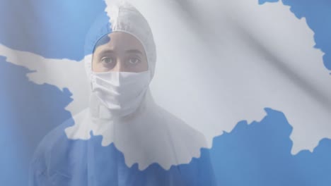 Antarctica-flag-waving-against-female-scientist-wearing-protective-clothes