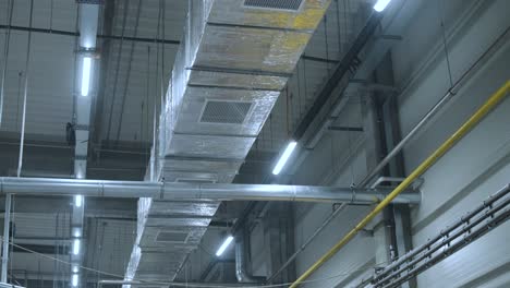 hvac duct cleaning, ventilation pipes in silver insulation material hanging from the ceiling inside new building.