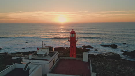 picturesque sunrise shining lighthouse standing stone shoreline aerial view.