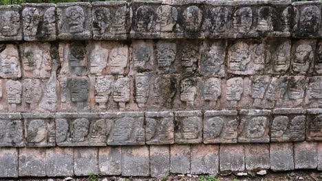 the platform of the skulls (tzompantli) detail of the bas-relief, at chichen itza archaeological site.