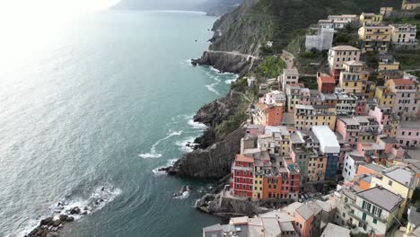 riomaggiore cinque terre italy aerial overhead tilt down of homes on ocean