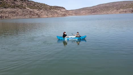 A-drone-shot-of-people-in-a-kayak-on-a-lake