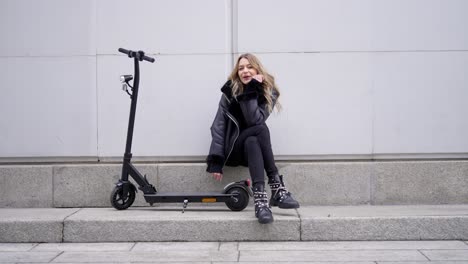 young woman with electric scooter