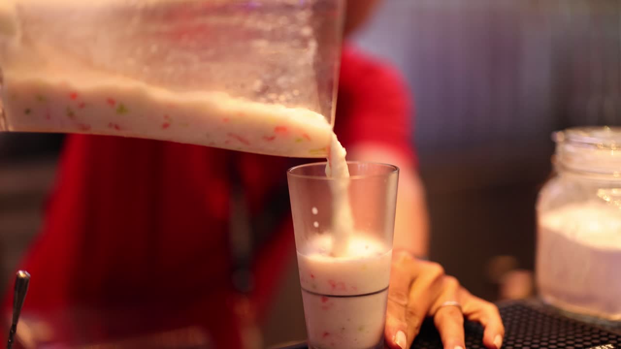 Pouring smoothie into a glass in Bangkok