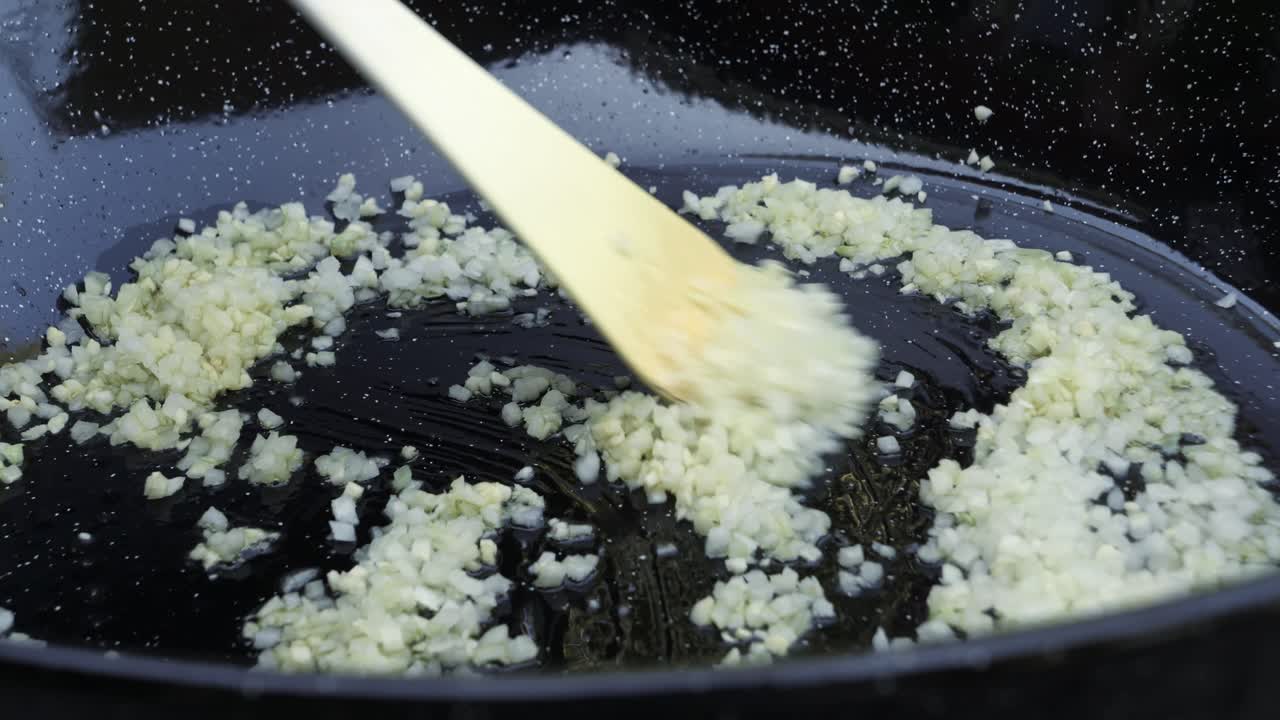 Stirring Risotto recipe ingredients in a non stick pan