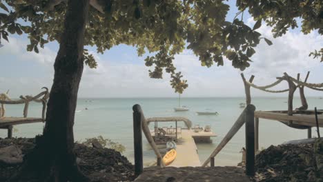 dreamy landscape of a beautiful beach in the caribbean. a paradisiac hotel in front of the beach with an amazing rustic pier to rest on vacation