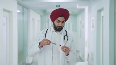 sikh indian doctor filling up an injection