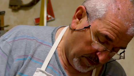 Italian-Sculptor-in-his-workshop-working-on-a-olive-wood-statue