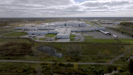 general motors auto plant in delta township, michigan with drone video moving up