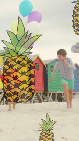 animation of pineapple icons over happy caucasian family running at beach