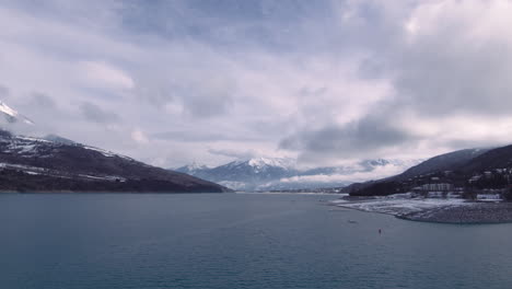 daytime time lapse of clouds above mountain lake in alps, pristine landscape