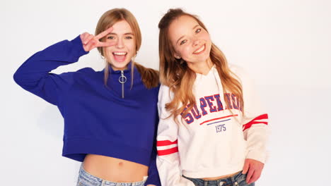 two young women in trendy sweatshirts