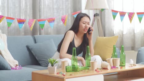 woman on phone during a party aftermath