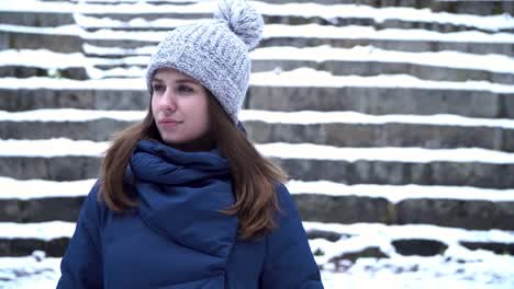 woman in winter clothing on snow covered steps