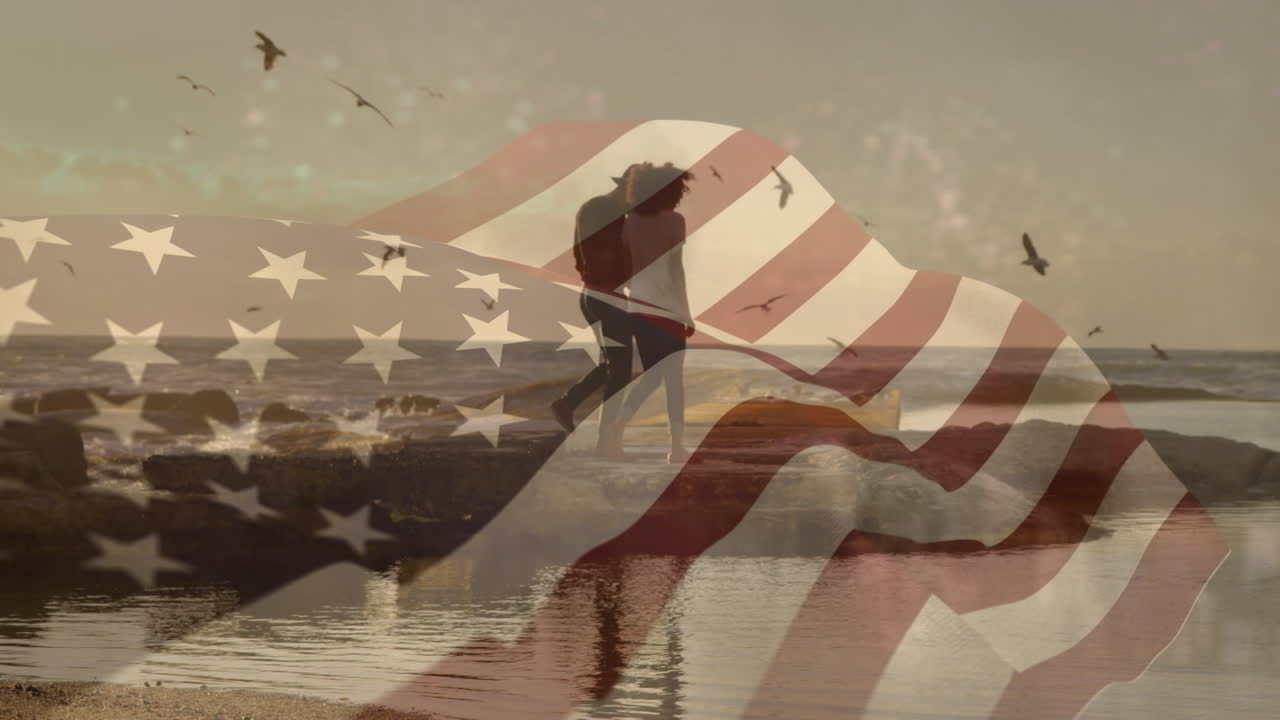 animación de la bandera de los estados unidos sobre una pareja afroamericana en la playa