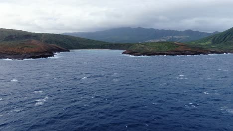 drone-pans-along-hanauma-bay-ocean-side-on-a-gloomy-day