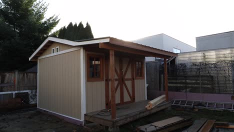 sun comes up behind a shed