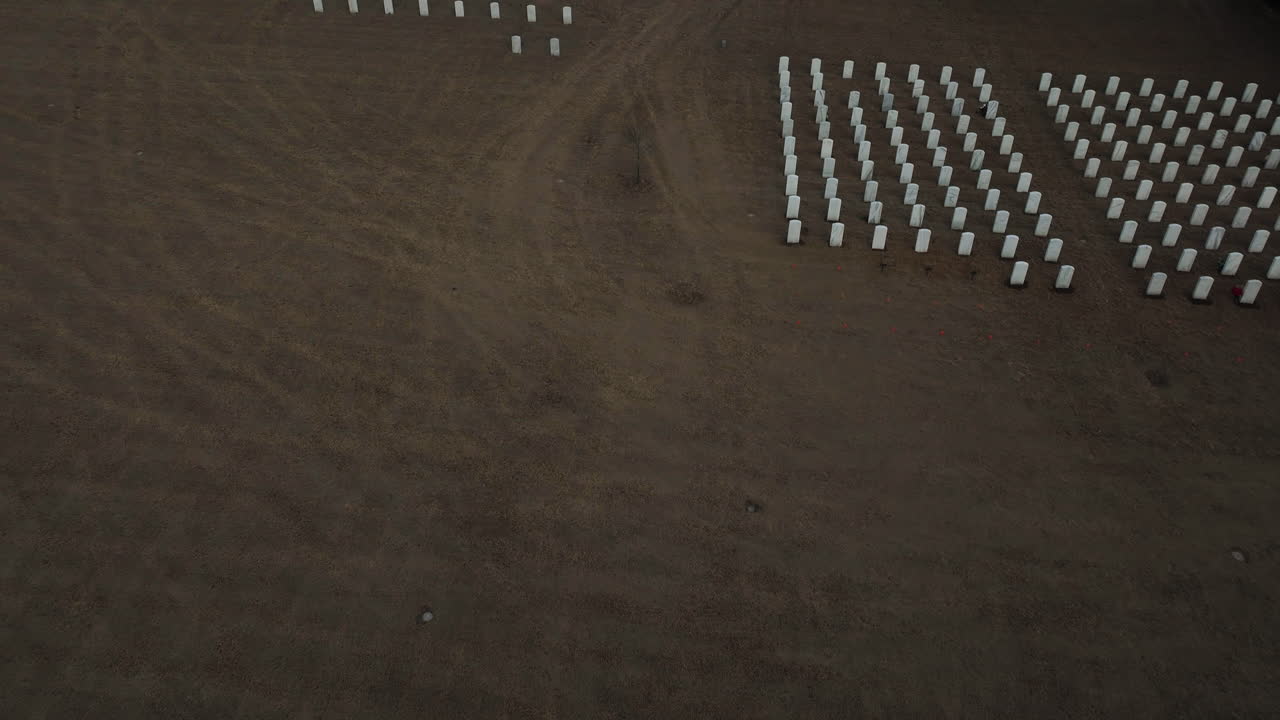 Bird's eye view of large cemetery in Fayetteville, Arkansas, tilt up reveals sky
