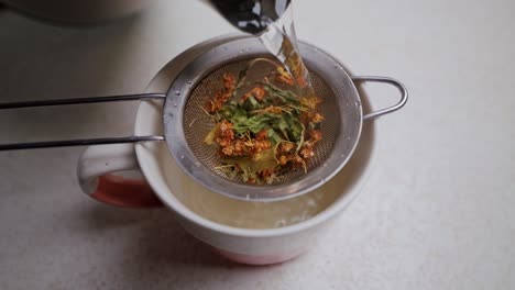 herbal remedy in countryside as boiling water prepares cold season infusion
