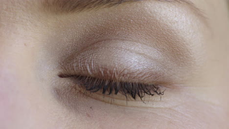 close up of woman eye blinking looking at camera