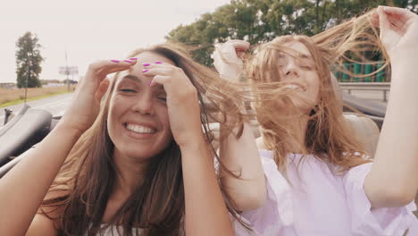 two girls having fun in a convertible